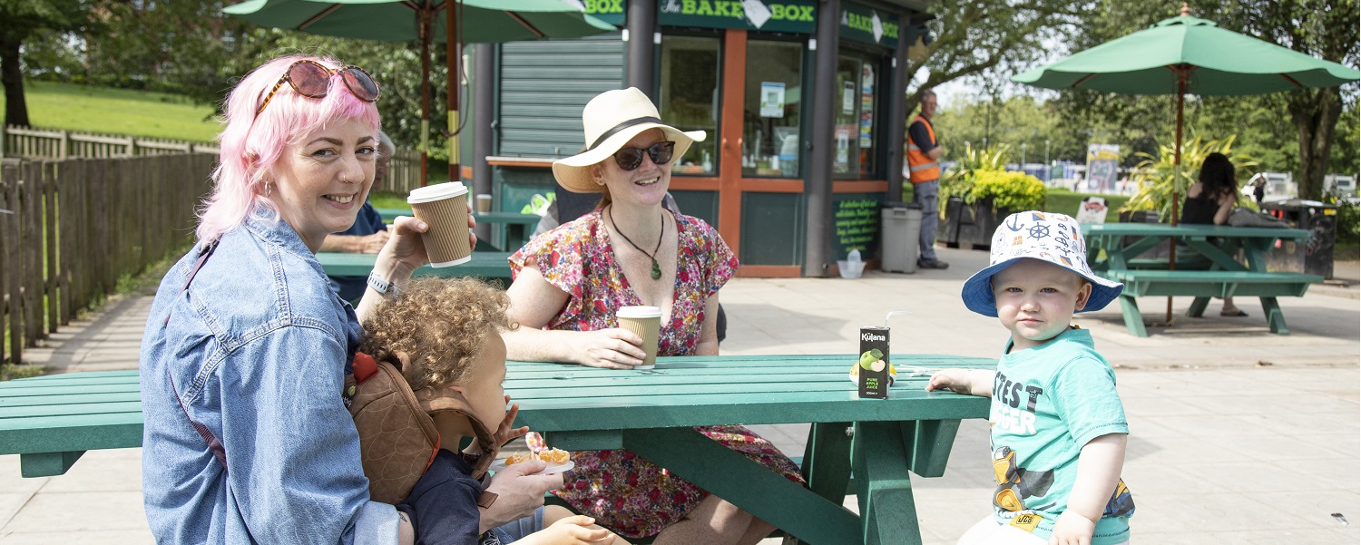 Two women and two children enjoying drinks outside the cafe