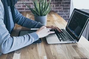 A person typing on a laptop.