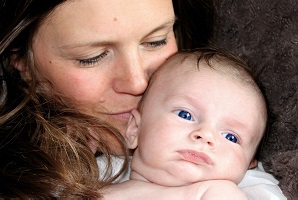 A young woman hugging a baby