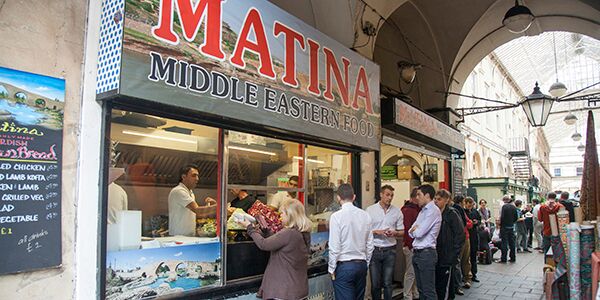 A queue of people outside a market cafe 