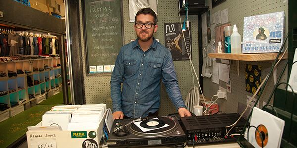 A man stood near a record player