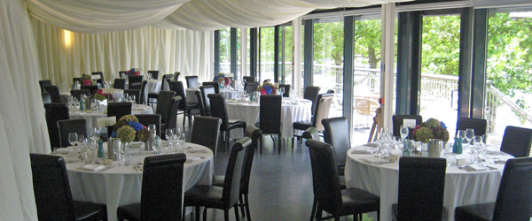 a room set up cabaret style for a wedding reception 